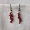 Scarlet Glow Drops: Handmade red earrings featuring six different shades of red glass seed beads, connected with bronze jump rings and matching hooks.