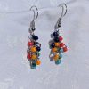 The Retro Vibes Color Block Earrings are 1970s-inspired red, yellow, light blue, and dark blue earrings with solid colors, featuring silver-colored jump rings and earring hooks.