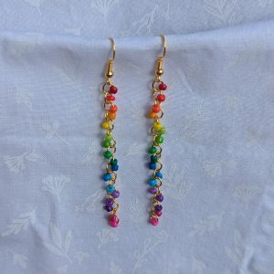 These handmade Golden Rainbow Rainbow Cascade earrings showcase a sleek, cascading design featuring 17 vibrant glass seed beads per earring.