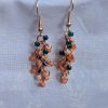 These vibrant Seaside Blossom Earrings feature a stunning blend of teal, pink, and cream glass seed beads with a variety of textures.