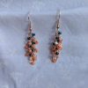 These vibrant Seaside Blossom Earrings feature a stunning blend of teal, pink, and cream glass seed beads with a variety of textures.