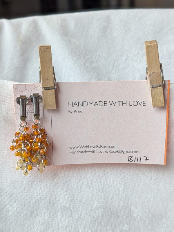 Savannah Roar: Tiger-themed clip-on earrings with 30 beads in five fiery shades of orange, connected with steel jump rings.