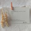 Orange Creamsicle earrings featuring 27 beads in gold-lined opal, matte orange, and gold-lined clear, linked with gold-colored jump rings and matching hooks.