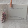 Watermelon Bliss earrings with pearly green and hot pink beads, steel-colored jump rings, and earring hooks.