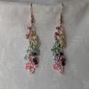 Radiance Lined Earrings: 27 clear glass beads, each lined in rainbow colors: red, yellow, seafoam, green, blue, purple, hot pink, and pale pink, connected with rose-gold-colored jump rings.