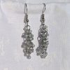 The Stormy Skies Earrings offer a cascade of blue-gray iridescent beads, reminiscent of the sky over the ocean before a storm. Featuring 22 beads and finished with sturdy jump rings and matching earring hooks, they are an elegant addition to any look.