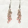 Caption: Blushed Bronze – Handmade dangle earrings featuring 18 beads in soft pink and mauve shades with bronze-colored jump rings and matching earring hooks.
