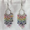 Radiant Cascade earrings with colorful rainbow beads hanging from silver-toned chandelier ornaments, connected by steel-colored jump rings and matching hooks.