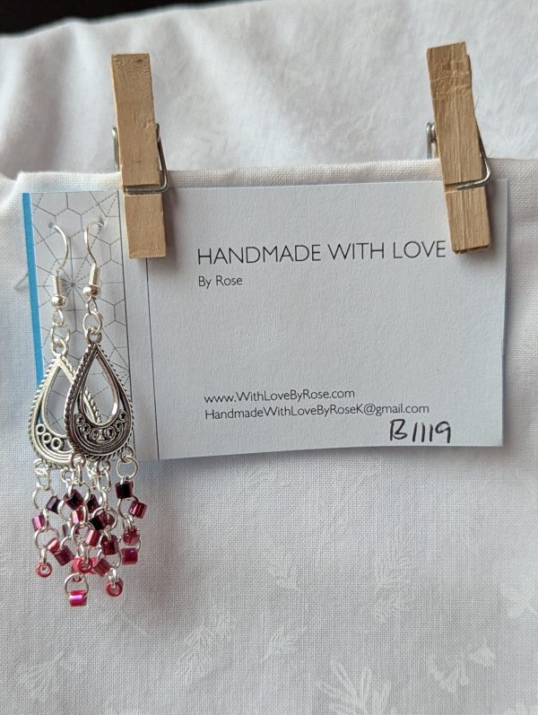 Crimson chandelier earrings with Tibetan ornament, featuring garnet, wine, dark red lined clear, and candy apple red beads.