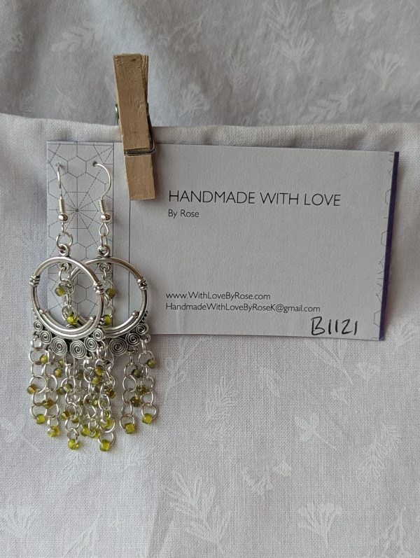 Lime Essence Chandelier Earrings with Tibetan ornaments, featuring three textures of lime green beads: green lined clear, silver-lined green, and lime-green lined green.