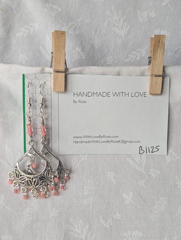 Soft Blossom chandelier earrings with Tibetan ornament, featuring 11 beads in pale pink and cream hues.