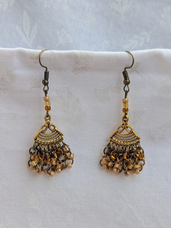 Desert Dusk Earrings: Antiqued gold chandelier-style earrings with 30 beads in silver-lined brown, silver-lined tan, and pearly beige, finished with bronze-colored hooks.