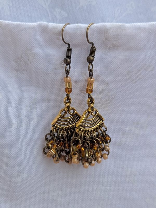 Desert Dusk Earrings: Antiqued gold chandelier-style earrings with 30 beads in silver-lined brown, silver-lined tan, and pearly beige, finished with bronze-colored hooks.