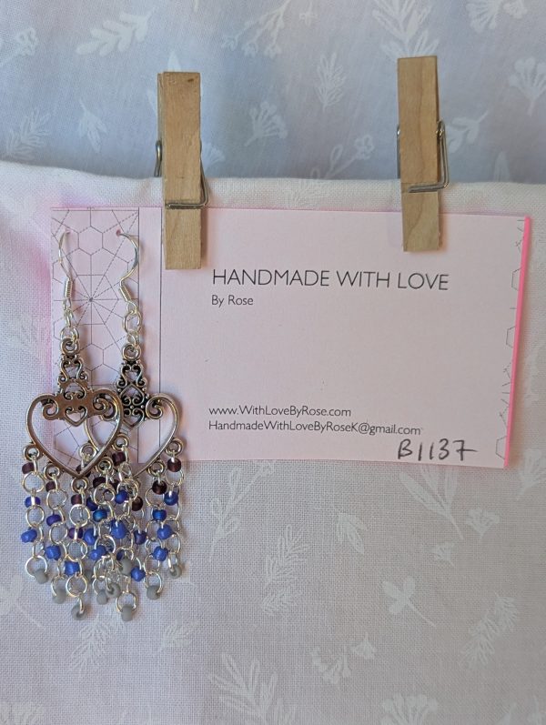 Twilight Romance Earrings: Pair of silver-colored heart earrings with intricate filigree tops and 20 dangling glass beads in deep red, blue, violet-blue, and frosted gray.