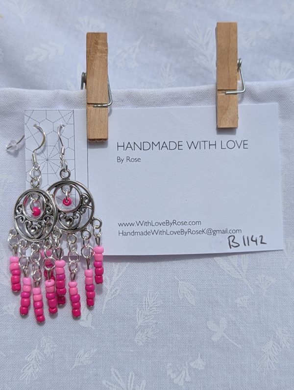 Fuchsia Bloom Earrings: Ornate silver circular earrings with 26 glass beads transitioning from pale ballet pink to vibrant fuchsia, connected by silver-toned jump rings and hooks.