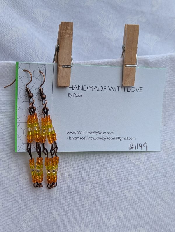 Citrus Mirage Earrings—Gradient earrings with 42 silver-lined beads each, transitioning from orange to yellow to white and back, connected with bronze-colored findings.