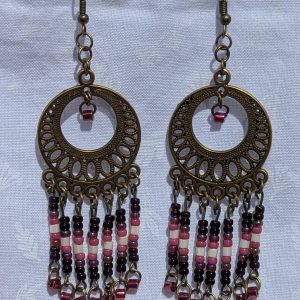 Desert Rose Sundial — Bronze filigree earrings with cascading glass beads in garnet, blush pink, ivory, rose, and crimson, arranged in five vertical strands.
