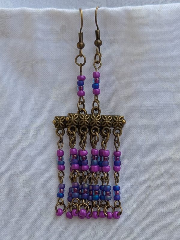 Festival of Lights — Bronze-tone earrings with floral Tibetan-style bars and five dangling strands of fuchsia, orchid pink, and sapphire blue glass beads.