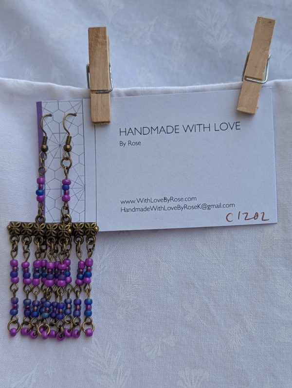 Festival of Lights — Bronze-tone earrings with floral Tibetan-style bars and five dangling strands of fuchsia, orchid pink, and sapphire blue glass beads.