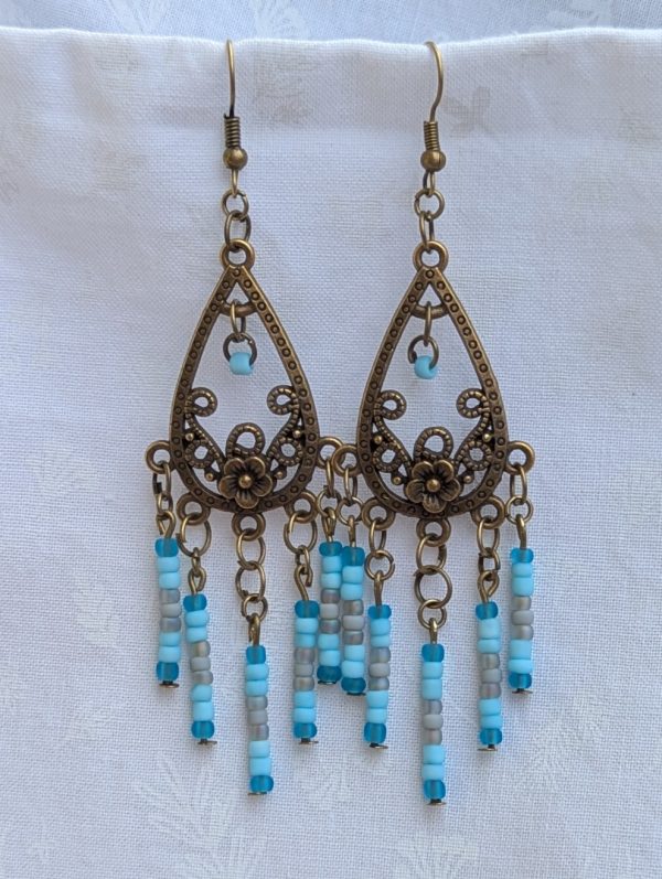 Winter Garden Earrings — Bronze teardrop earrings with floral filigree and dangling strands of glacier blue, sky blue, gray, and turquoise glass beads.