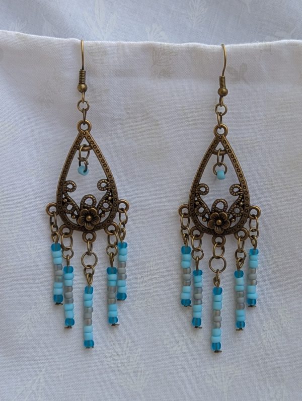 Winter Garden Earrings — Bronze teardrop earrings with floral filigree and dangling strands of glacier blue, sky blue, gray, and turquoise glass beads.