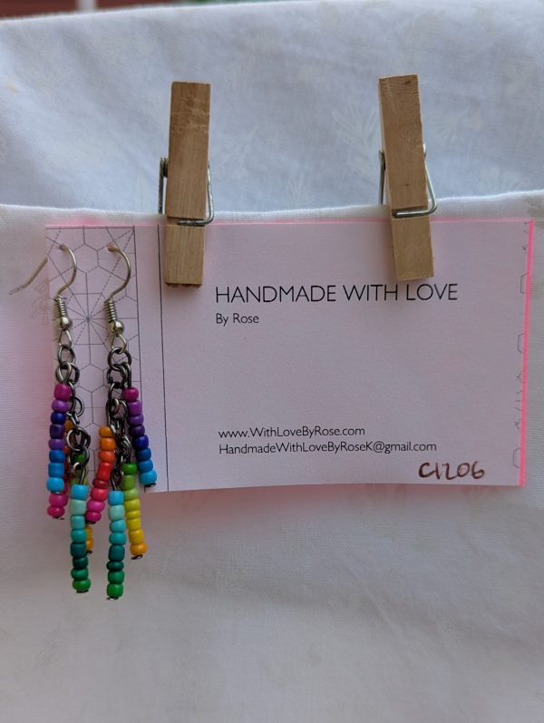 Rainbow Glow Cascade Earrings: Dangle earrings with 32 unique rainbow-colored seed beads arranged in vertical strands, connected by tungsten and steel findings.