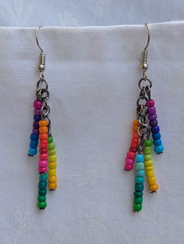 Rainbow Glow Cascade Earrings: Dangle earrings with 32 unique rainbow-colored seed beads arranged in vertical strands, connected by tungsten and steel findings.