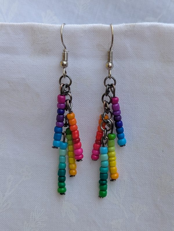 Rainbow Glow Cascade Earrings: Dangle earrings with 32 unique rainbow-colored seed beads arranged in vertical strands, connected by tungsten and steel findings.