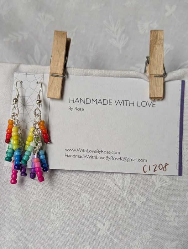 Handmade gradient rainbow earrings featuring 35 colorful seed beads per earring, arranged in 7 soft color gradients and hung from silver-toned posts with silver hooks.