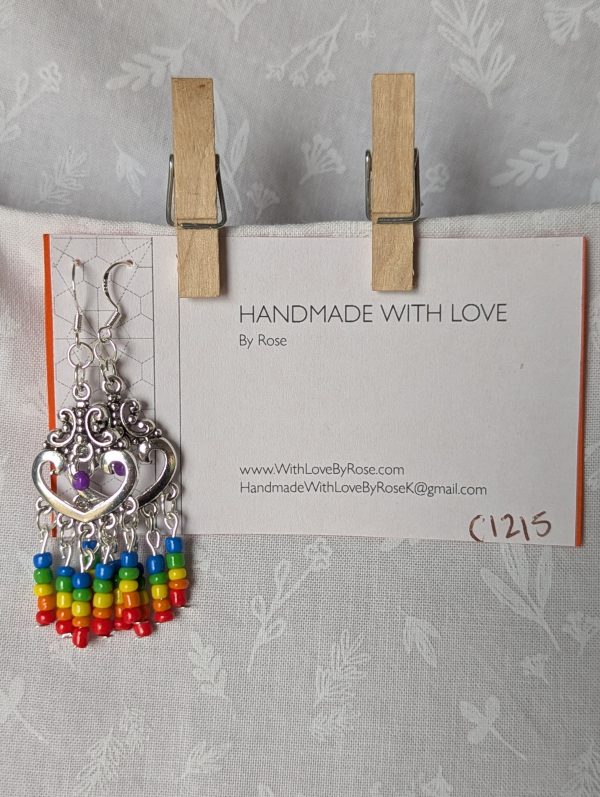 Rainbow heart earrings with silver filigree hearts and colorful glass seed bead strands in red, orange, yellow, green, blue, and purple.