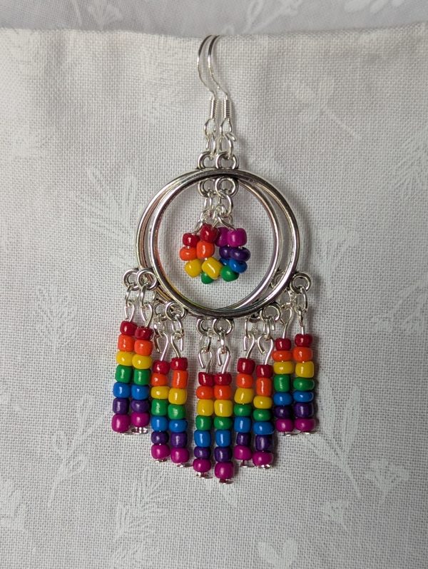 Rainbow circle earrings with silver hoops, five dangling rainbow strands, and a circular rainbow bead charm in the center.
