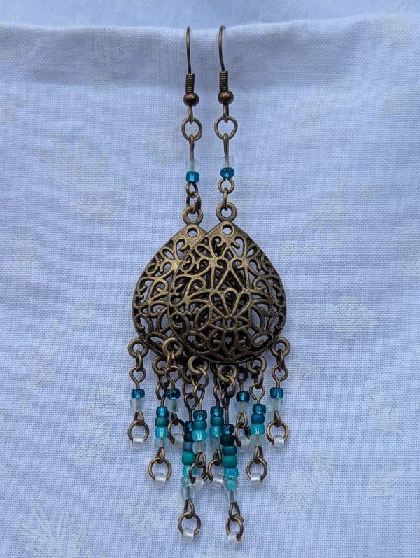 Ocean Lace Earrings; Bronze teardrop earrings with teal gradient beads from dark green to white.