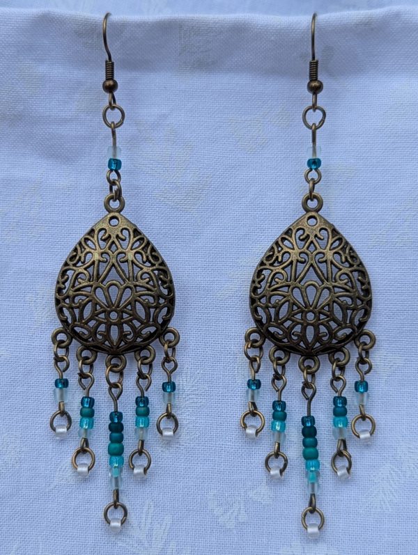 Ocean Lace Earrings; Bronze teardrop earrings with teal gradient beads from dark green to white.