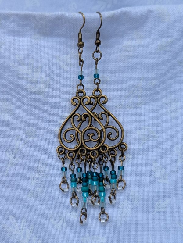 Tidal Filigree Earrings: bronze earrings with teal gradient beaded strands from dark to light.