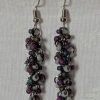 Shadow Galaxy Earrings with 27 beads in matte gray, frosted plum, and iridescent galaxy tones, linked with tungsten-colored rings and steel hooks.