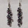Shadow Galaxy Earrings with 27 beads in matte gray, frosted plum, and iridescent galaxy tones, linked with tungsten-colored rings and steel hooks.