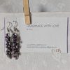 Shadow Galaxy Earrings with 27 beads in matte gray, frosted plum, and iridescent galaxy tones, linked with tungsten-colored rings and steel hooks.