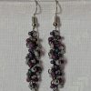 Shadow Galaxy Earrings with 27 beads in matte gray, frosted plum, and iridescent galaxy tones, linked with tungsten-colored rings and steel hooks.