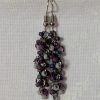 Shadow Galaxy Earrings with 27 beads in matte gray, frosted plum, and iridescent galaxy tones, linked with tungsten-colored rings and steel hooks.