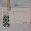 Ocean Whisper Earrings: A pair of handmade teal dangle earrings with 27 seafoam, silver-lined, and iridescent cyan beads. Suspended on silver jump rings with sterling silver hooks.