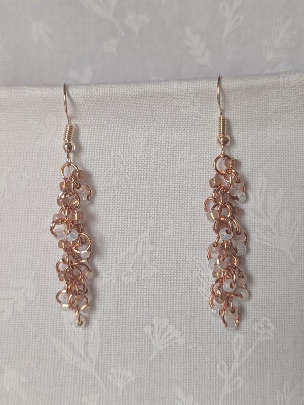 Rosy Lumina Earrings with 27 blush pink, pearly white, and translucent rose beads on copper jump rings with rose-gold earring hooks.