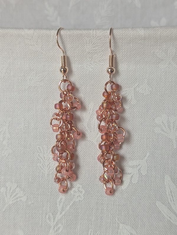 Blush Bloom Earrings with 27 soft pink glass beads in matte, translucent, and iridescent finishes, on copper rings with rose-gold earring hooks.