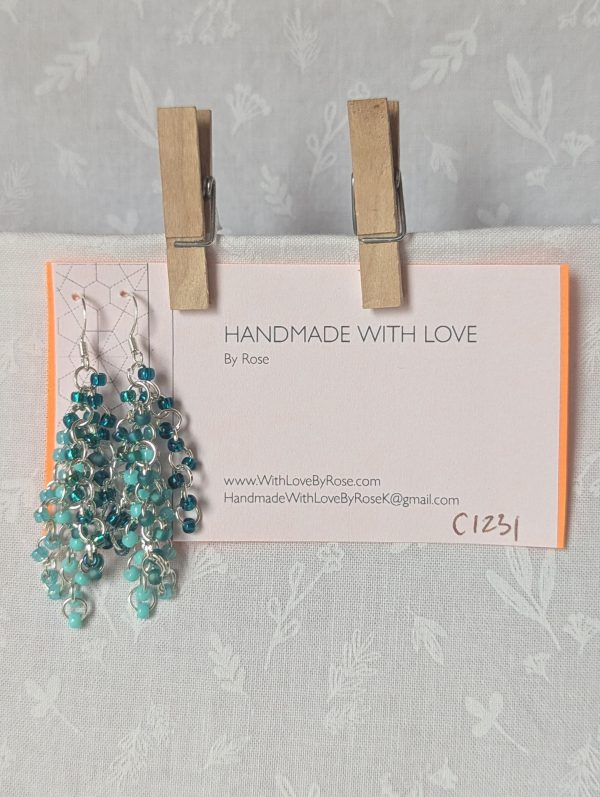 Ocean Depth Earrings featuring 45 glass beads in five teal shades and textures, connected with silver jump rings and sterling silver hooks.
