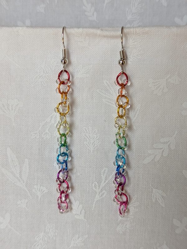 Prismatic Dewdrop Earrings with 28 clear glass beads wrapped around 14 rainbow-colored jump rings, hanging from steel-colored earring hooks.