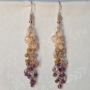 Handmade Twilight Garden earrings featuring 30 gradient beads from cream to purple on rose-gold jump rings with matching hooks.