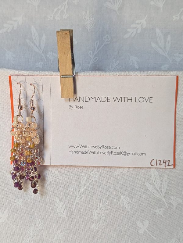 Handmade Twilight Garden earrings featuring 30 gradient beads from cream to purple on rose-gold jump rings with matching hooks.
