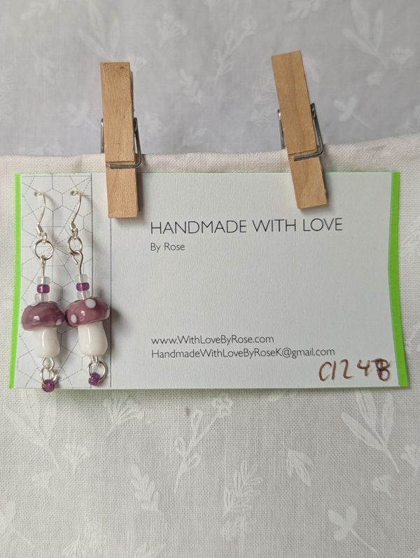 Handmade purple mushroom earrings with glass toadstools, purple and white seed beads, and sterling silver hooks.