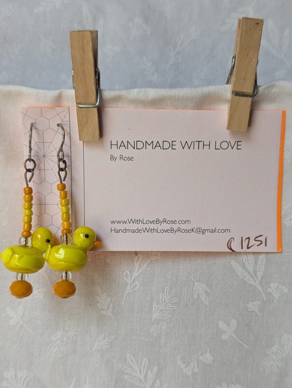 Handmade duck earrings with yellow glass duck beads, orange and yellow seed beads, Czech orange bead, and clear accents on titanium hooks.