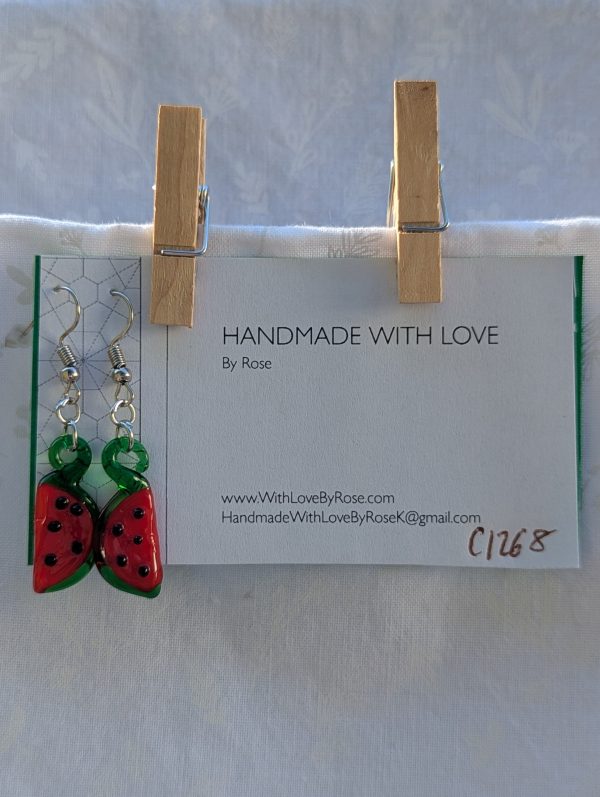 Handmade glass watermelon slice earrings with pink-red centers, green rinds, and sterling silver hooks.