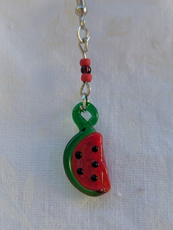 Handmade glass watermelon slice earrings with pink-red centers, green rinds, and sterling silver hooks.